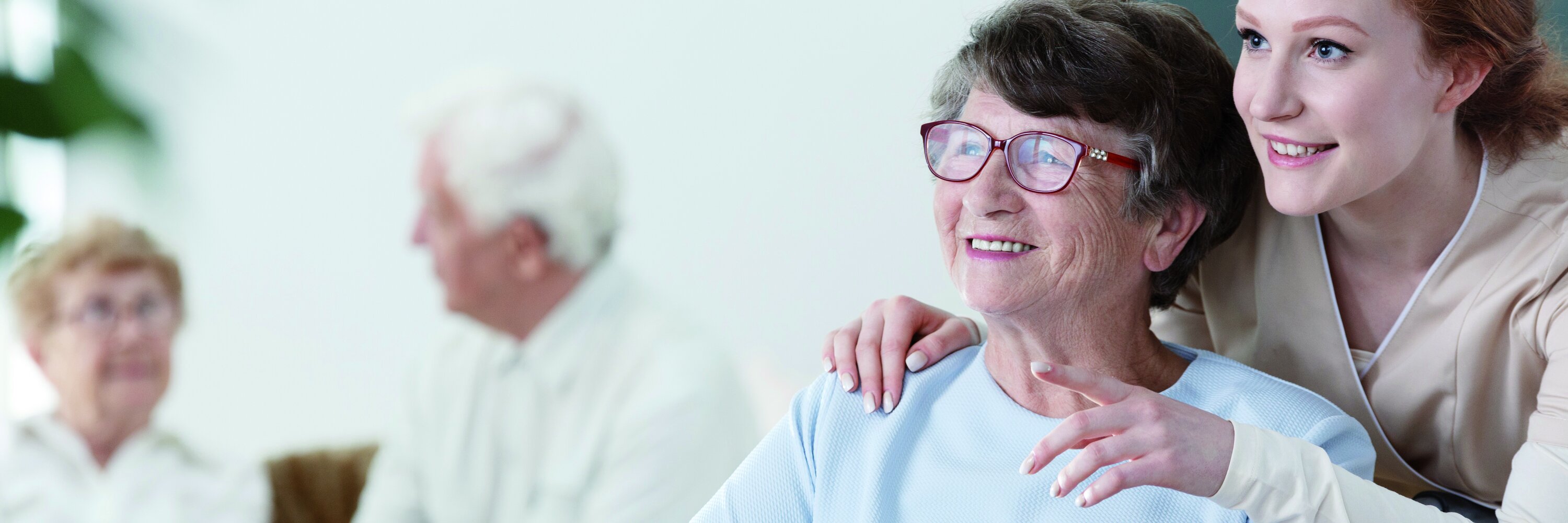 Pflegekraft kümmert sich um Seniorin